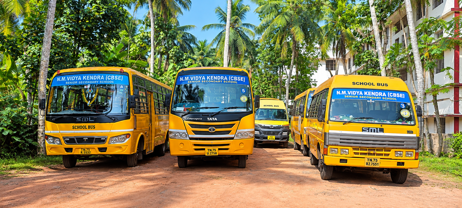 NMVK School bus fleet parked on campus